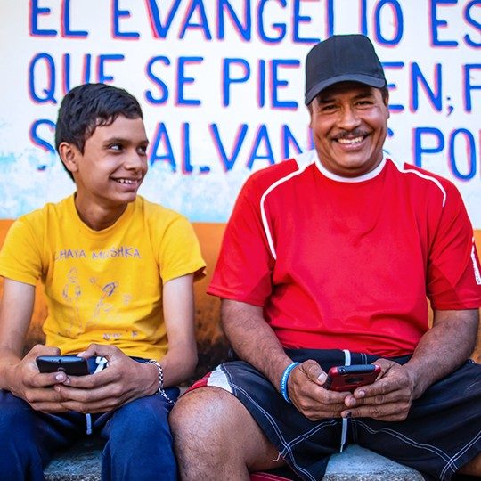 father and son connecting globally on mobile