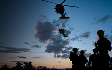 A United States military operation with troops and helicopters connected by Viasat's secure, resilient connectivity solutions